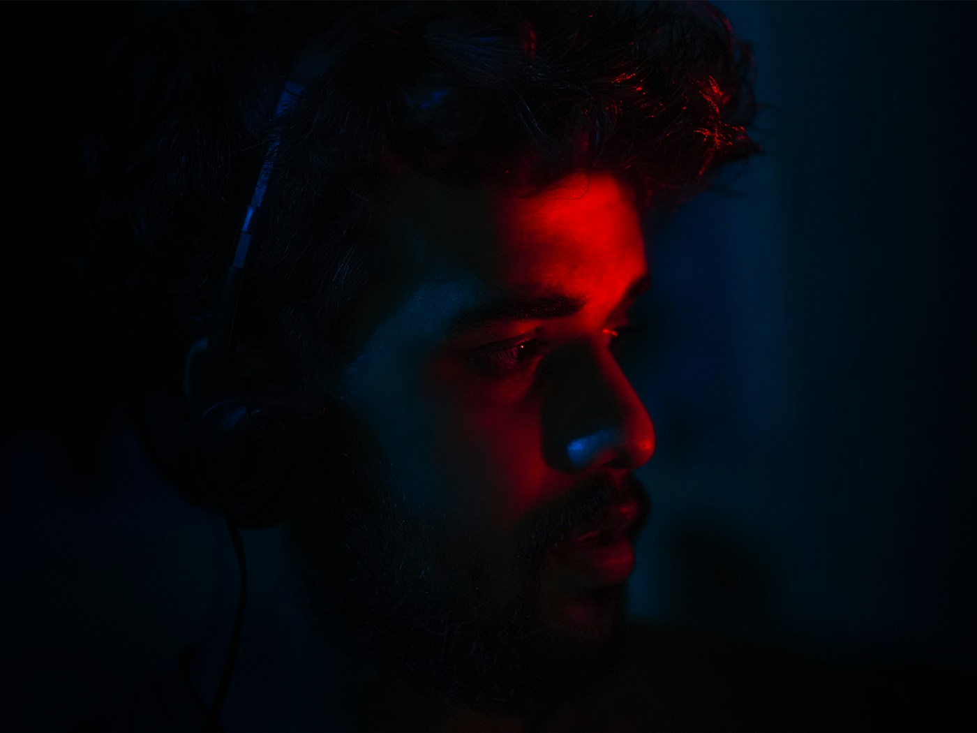A person mixing audio with headphones on